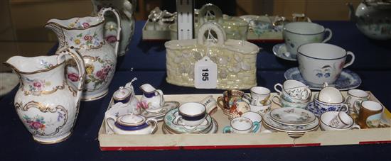 A Belleek basket, two 19th century flower-decorated jugs and a quantity of miniature tableware